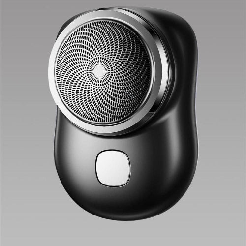 Black electric shaver on a gray background